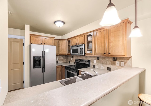 690 32nd St Unit B210, Bellingham, WA 98225 - kitchen with appliances with stainless steel finishes, decorative backsplash, glass insert cabinets, and decorative light fixtures
