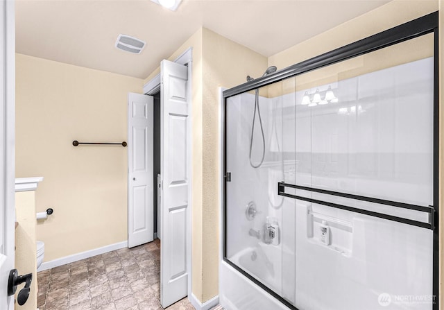 690 32nd St Unit B210, Bellingham, WA 98225 - bathroom featuring bath / shower combo with glass door and stone finish floors