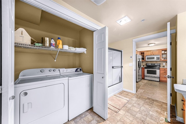 690 32nd St Unit B210, Bellingham, WA 98225 - laundry area with washing machine and dryer and stone finish flooring