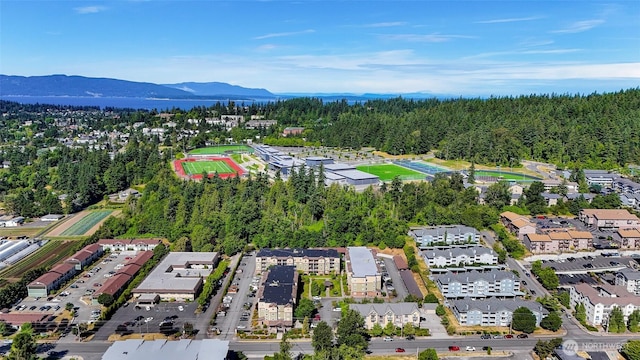 690 32nd St Unit B210, Bellingham, WA 98225 - aerial overview of property's location with a mountain backdrop and a heavily wooded area