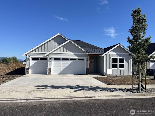 2080 Bowfin Way, Lynden, WA 98264 - view of front facade featuring board and batten siding, an attached garage, concrete driveway, and stone siding