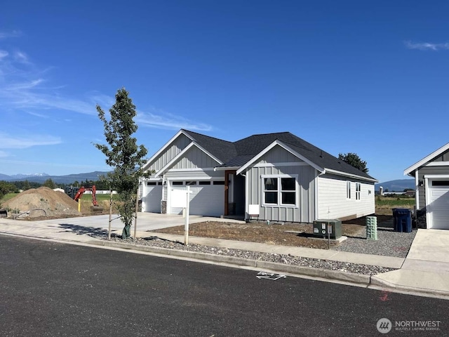2080 Bowfin Way, Lynden, WA 98264 - view of front of house with board and batten siding, driveway, a garage, and roof with shingles