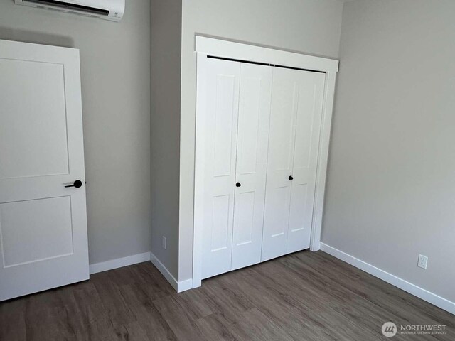 2080 Bowfin Way, Lynden, WA 98264 - unfurnished bedroom featuring an AC wall unit, wood finished floors, and a closet