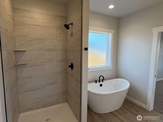 2080 Bowfin Way, Lynden, WA 98264 - full bathroom featuring wood finished floors, tiled shower, a freestanding tub, and recessed lighting