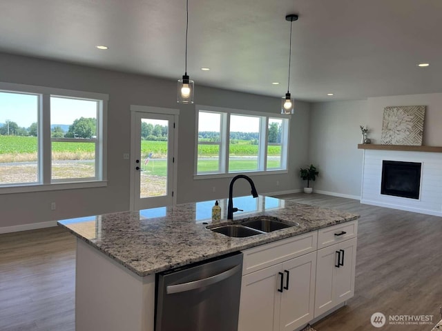 2080 Bowfin Way, Lynden, WA 98264 - kitchen featuring stainless steel dishwasher, light wood finished floors, white cabinetry, a fireplace, and recessed lighting