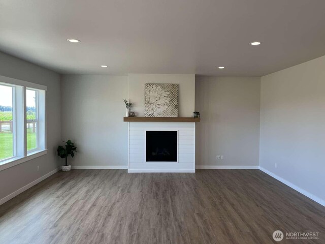 2080 Bowfin Way, Lynden, WA 98264 - unfurnished living room with wood finished floors, recessed lighting, and a fireplace