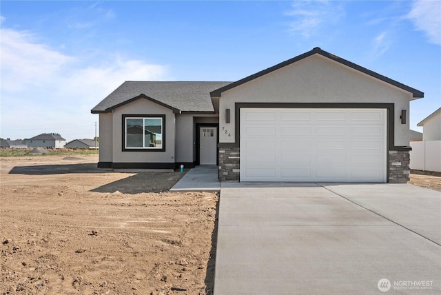 1517 7th Ave NE, Quincy, WA 98848 - ranch-style house with stucco siding, driveway, stone siding, and an attached garage