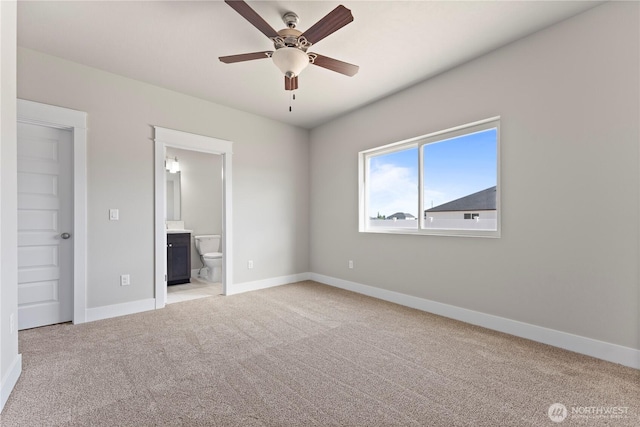 1517 7th Ave NE, Quincy, WA 98848 - unfurnished bedroom featuring light colored carpet, ensuite bath, and a ceiling fan