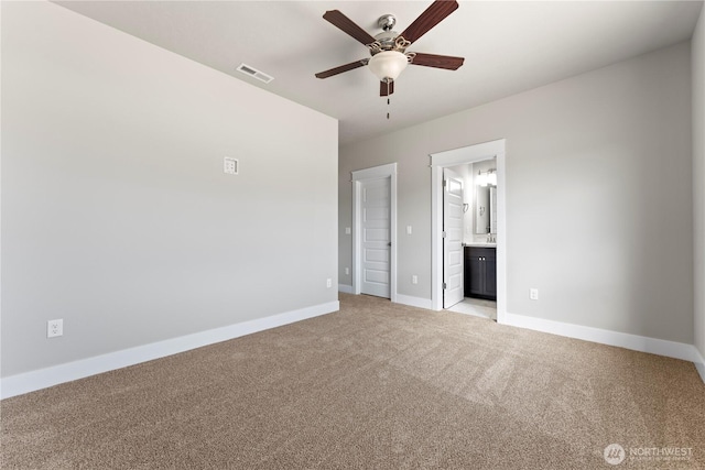 1517 7th Ave NE, Quincy, WA 98848 - unfurnished bedroom featuring light colored carpet, connected bathroom, and ceiling fan