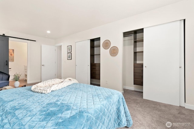 2016 3rd Ct SE, Auburn, WA 98002 - carpeted bedroom featuring two closets, a barn door, and recessed lighting
