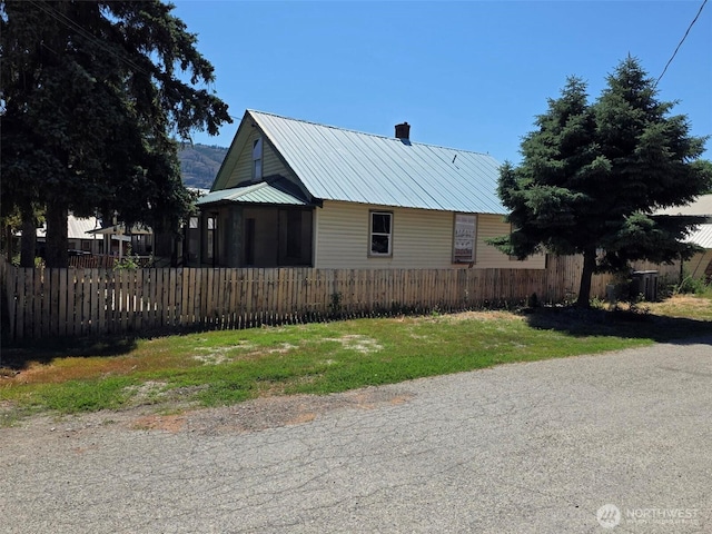 322 14th Ave, Oroville, WA 98844 - view of side of home featuring a chimney and a metal roof