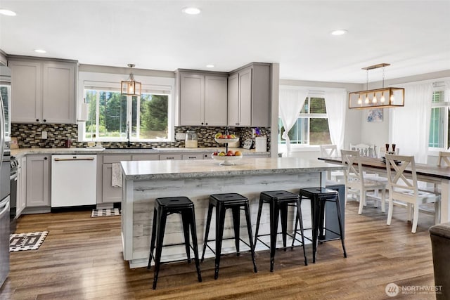 8984 Delta Line Rd, Custer, WA 98240 - kitchen featuring gray cabinetry, white dishwasher, healthy amount of natural light, a breakfast bar area, and recessed lighting