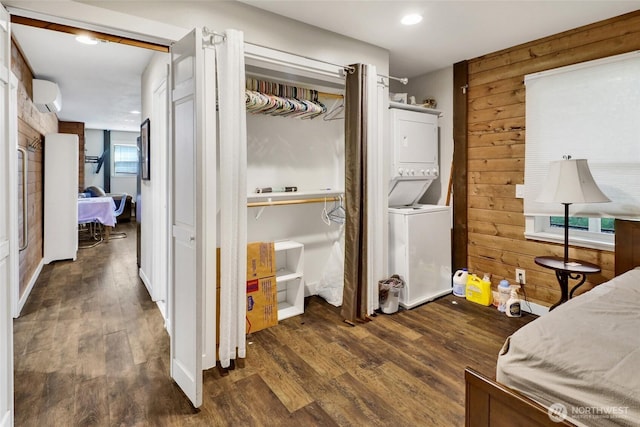 8984 Delta Line Rd, Custer, WA 98240 - bedroom with stacked washer / dryer, wood finished floors, a wall unit AC, wooden walls, and a closet