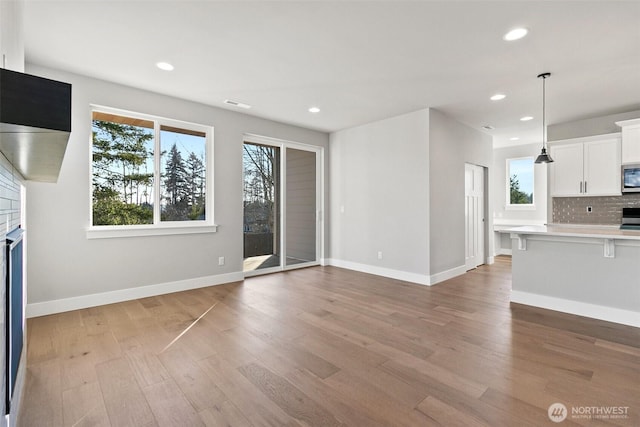 15627LOT15 SE 257th St, Covington, WA 98042 - unfurnished living room featuring light wood-style floors, recessed lighting, and a fireplace