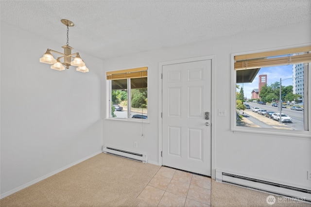 604 N 3rd St Unit 8, Tacoma, WA 98403 - foyer entrance featuring a baseboard radiator, a chandelier, a textured ceiling, and light carpet