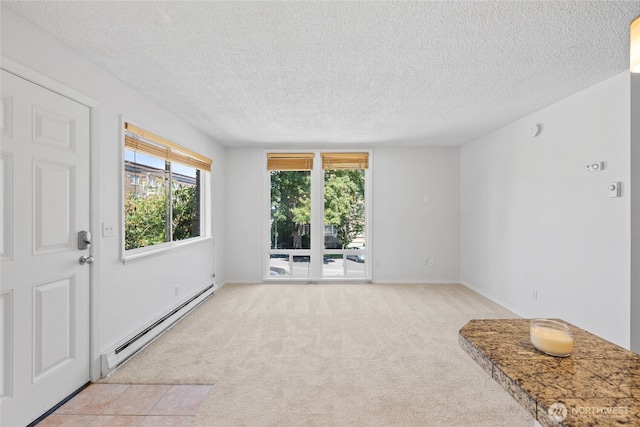 604 N 3rd St Unit 8, Tacoma, WA 98403 - unfurnished room with baseboard heating, a textured ceiling, and light colored carpet