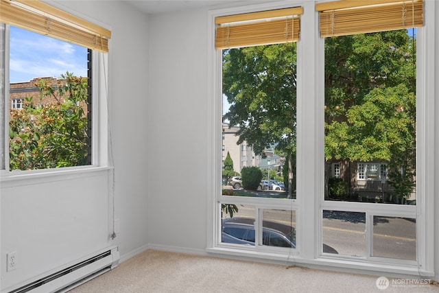 604 N 3rd St Unit 8, Tacoma, WA 98403 - empty room with a baseboard heating unit, carpet, and plenty of natural light