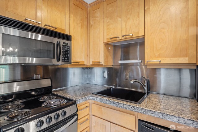 604 N 3rd St Unit 8, Tacoma, WA 98403 - kitchen with tile counters, stainless steel appliances, tasteful backsplash, and light brown cabinetry