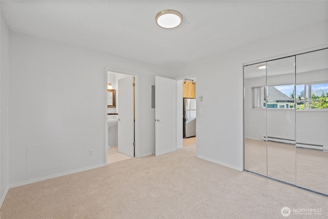 604 N 3rd St Unit 8, Tacoma, WA 98403 - unfurnished bedroom featuring carpet flooring, freestanding refrigerator, a closet, a baseboard heating unit, and ensuite bath
