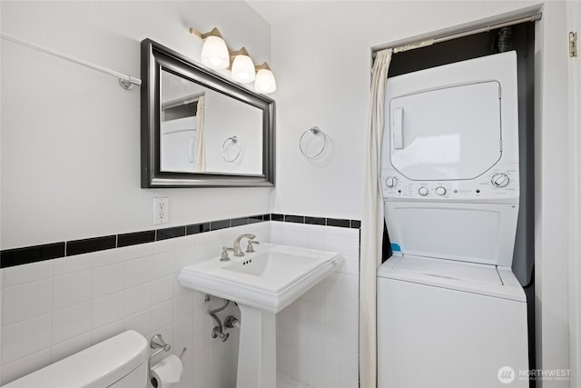 604 N 3rd St Unit 8, Tacoma, WA 98403 - bathroom with stacked washer / drying machine, tile walls, and a wainscoted wall