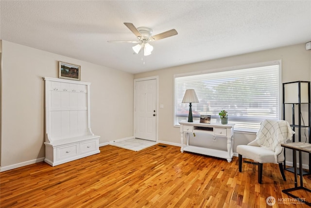 1106 SE 26th St, Auburn, WA 98002 - sitting room with light wood-style floors, a ceiling fan, and a textured ceiling