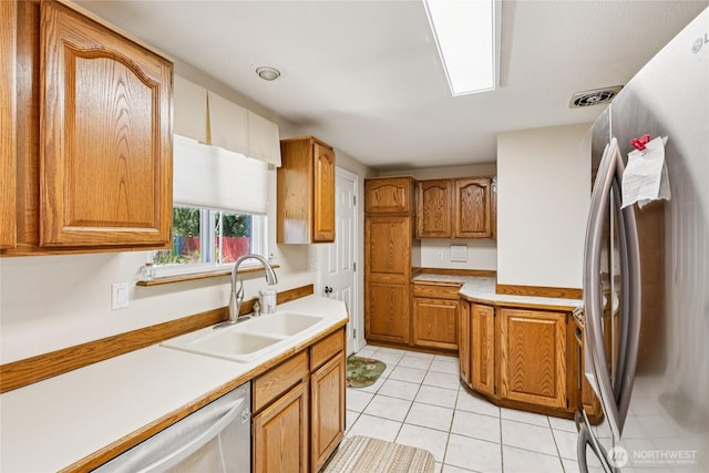 1106 SE 26th St, Auburn, WA 98002 - kitchen featuring freestanding refrigerator, brown cabinets, light tile patterned flooring, and light countertops