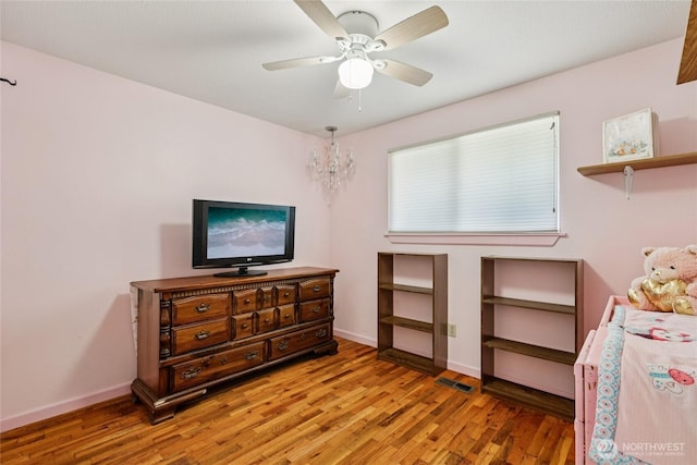 1106 SE 26th St, Auburn, WA 98002 - bedroom featuring light wood-type flooring, a ceiling fan, and a chandelier