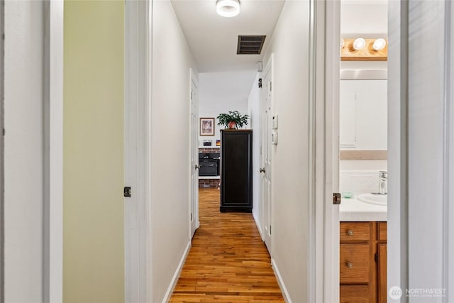 1106 SE 26th St, Auburn, WA 98002 - hallway featuring light wood-style flooring and baseboards