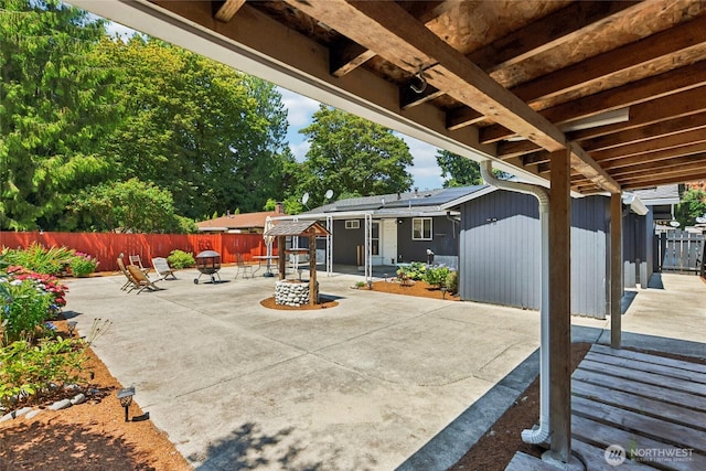 1106 SE 26th St, Auburn, WA 98002 - fenced backyard with a patio, an outdoor fire pit, and an outbuilding
