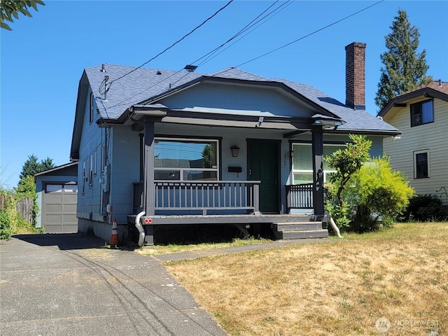 3827 A St, Tacoma, WA 98418 - view of front of house featuring covered porch, a front lawn, roof with shingles, and a garage