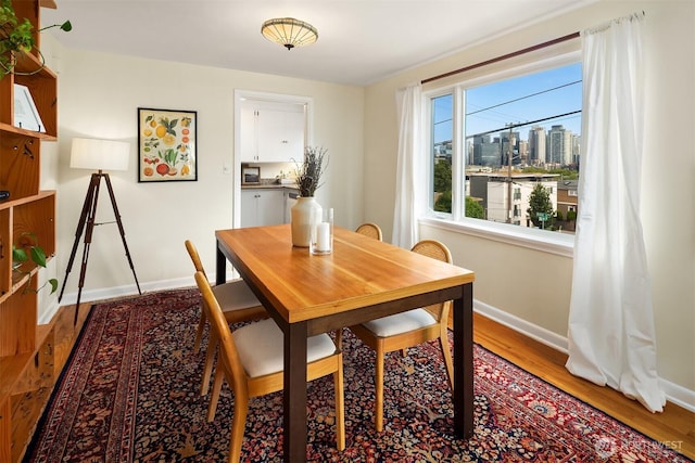 228 Aloha St Unit 403, Seattle, WA 98109 - dining room featuring baseboards and wood finished floors