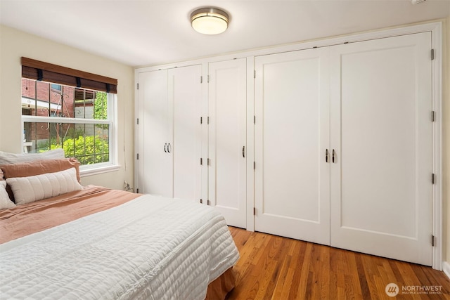 228 Aloha St Unit 403, Seattle, WA 98109 - bedroom featuring multiple closets and light wood-type flooring