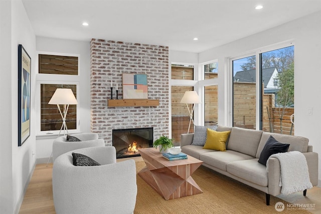 1261 NE 100th St, Seattle, WA 98125 - living room featuring a fireplace, wood finished floors, and recessed lighting