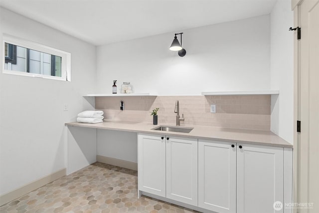 1261 NE 100th St, Seattle, WA 98125 - kitchen with open shelves, backsplash, light countertops, and white cabinetry