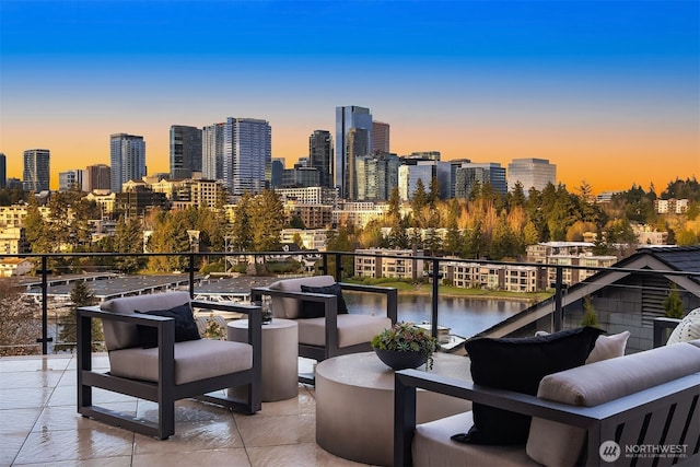 9630 SE 5th St, Bellevue, WA 98004 - patio terrace at dusk featuring a balcony, a water view, an outdoor hangout area, and a skyline view