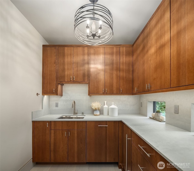 9630 SE 5th St, Bellevue, WA 98004 - kitchen with light countertops, backsplash, a chandelier, and brown cabinets