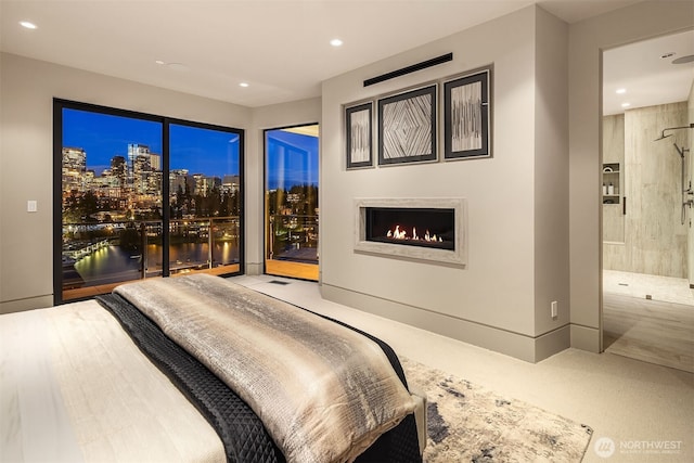 9630 SE 5th St, Bellevue, WA 98004 - bedroom featuring recessed lighting, a lit fireplace, access to exterior, and ensuite bathroom
