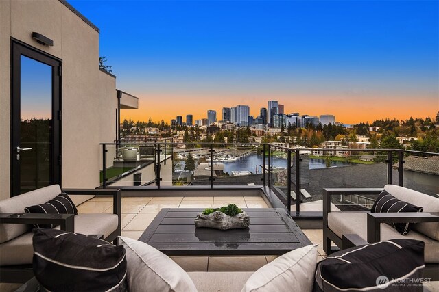 9630 SE 5th St, Bellevue, WA 98004 - balcony at dusk featuring a skyline view and a water view