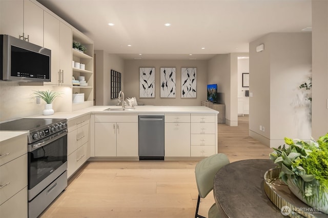 9630 SE 5th St, Bellevue, WA 98004 - kitchen featuring stainless steel appliances, open shelves, a peninsula, light wood finished floors, and light countertops