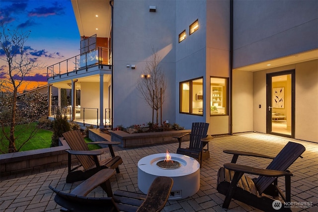 9630 SE 5th St, Bellevue, WA 98004 - patio terrace at dusk with a balcony, an outdoor fire pit, and a patio