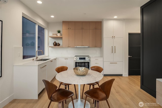3608 Francis Ave N, Seattle, WA 98103 - kitchen featuring oven, light wood-type flooring, light countertops, recessed lighting, and open shelves