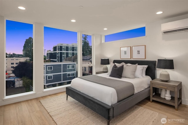 3608 Francis Ave N, Seattle, WA 98103 - bedroom with a wall unit AC, wood finished floors, expansive windows, recessed lighting, and a city view