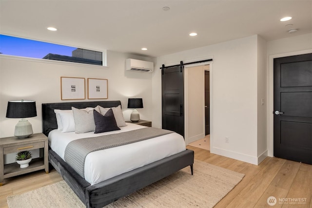 3608 Francis Ave N, Seattle, WA 98103 - bedroom featuring a barn door, light wood finished floors, a wall mounted AC, and recessed lighting
