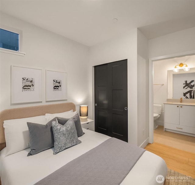3608 Francis Ave N, Seattle, WA 98103 - bedroom with light wood-style flooring and connected bathroom