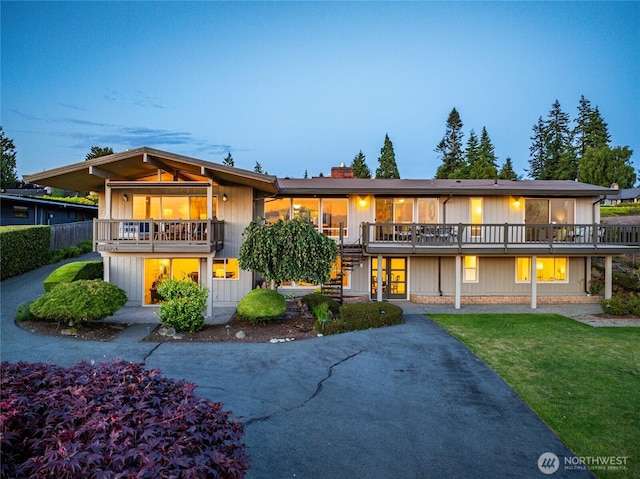 18354 Ridgefield Rd NW, Shoreline, WA 98177 - view of front of property featuring stairs, a chimney, a lawn, and a balcony