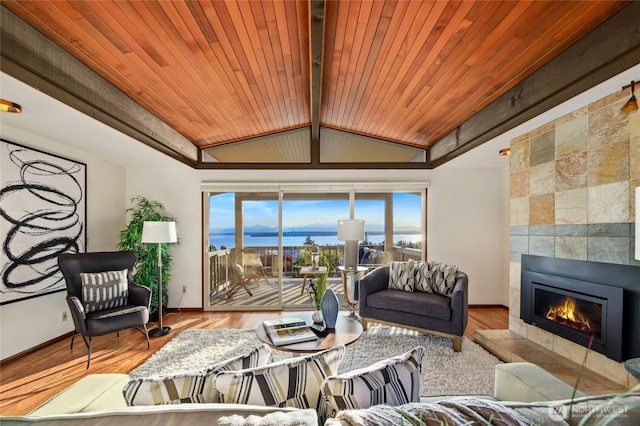 18354 Ridgefield Rd NW, Shoreline, WA 98177 - living area featuring a tile fireplace, wooden ceiling, a water view, and wood finished floors