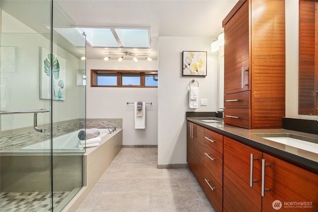 18354 Ridgefield Rd NW, Shoreline, WA 98177 - full bath featuring double vanity, a garden tub, a shower stall, and a skylight