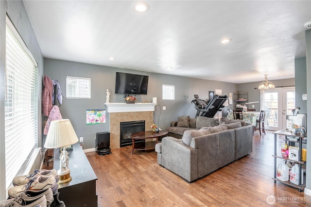 9211 Carys St SE, Yelm, WA 98597 - living room with a tiled fireplace, wood finished floors, healthy amount of natural light, and recessed lighting