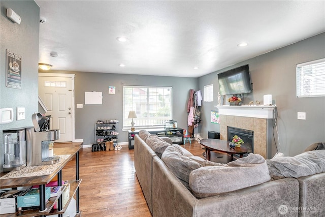 9211 Carys St SE, Yelm, WA 98597 - living area featuring a fireplace, wood finished floors, plenty of natural light, and recessed lighting