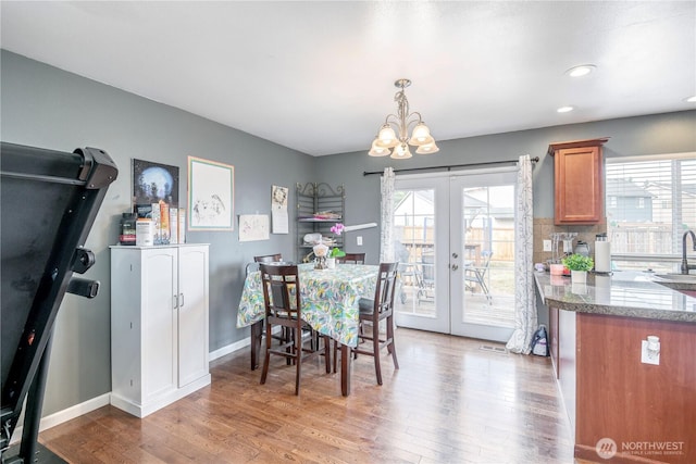 9211 Carys St SE, Yelm, WA 98597 - dining room with a chandelier, french doors, light wood-style floors, and recessed lighting